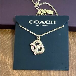 Coach Gold Pretzel Pendant Necklace with Pink Stones